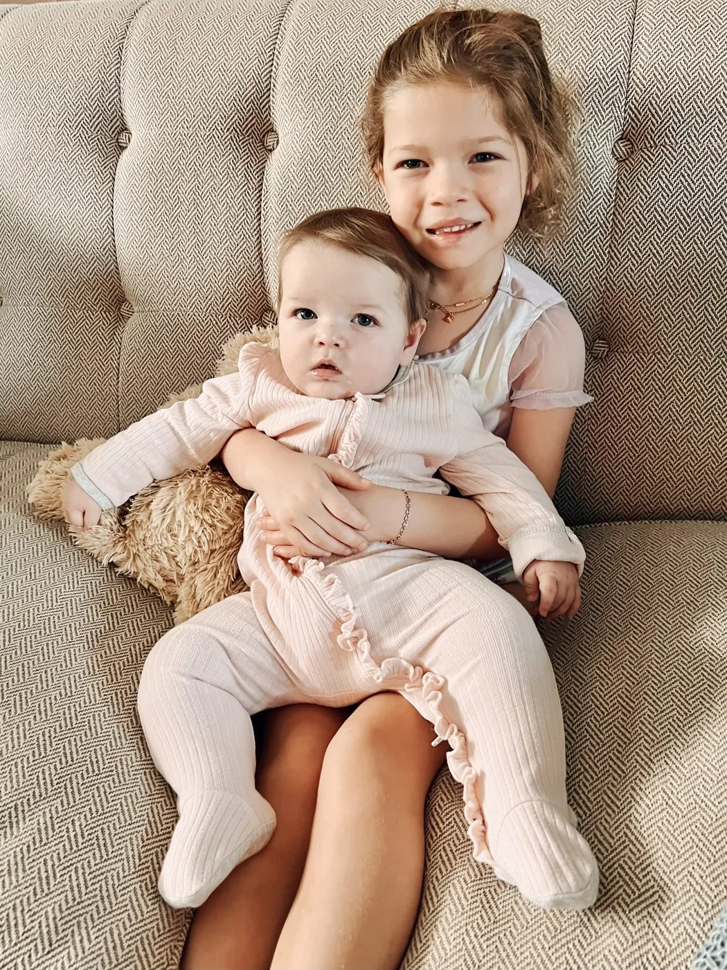 Isa’s big sister Olivia holding baby Isa