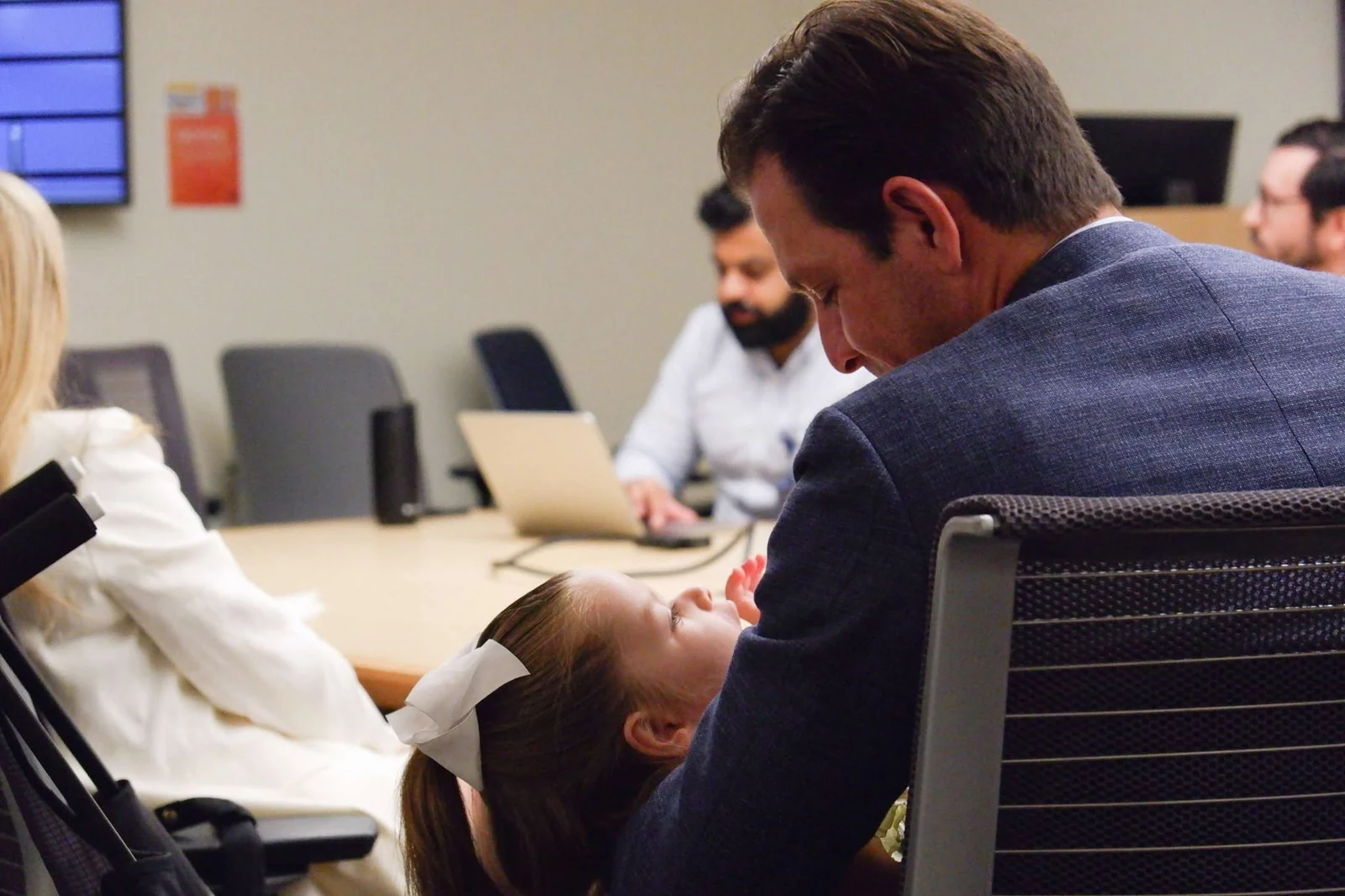 Isa in her father Chris Lazzara&rsquo;s arms during the opening-day gathering at the Fixel Institute