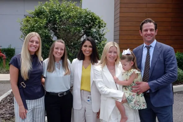 Kristen Cain, Amber Denton, Dr. Bhavana Patel, Rachel Lazzara holding Isa, and Chris Lazzara outside the Fixel Institute