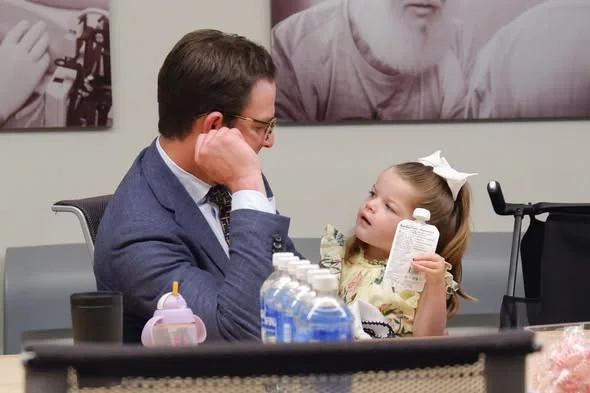 Isa and her father Chris Lazzara at the table on opening day